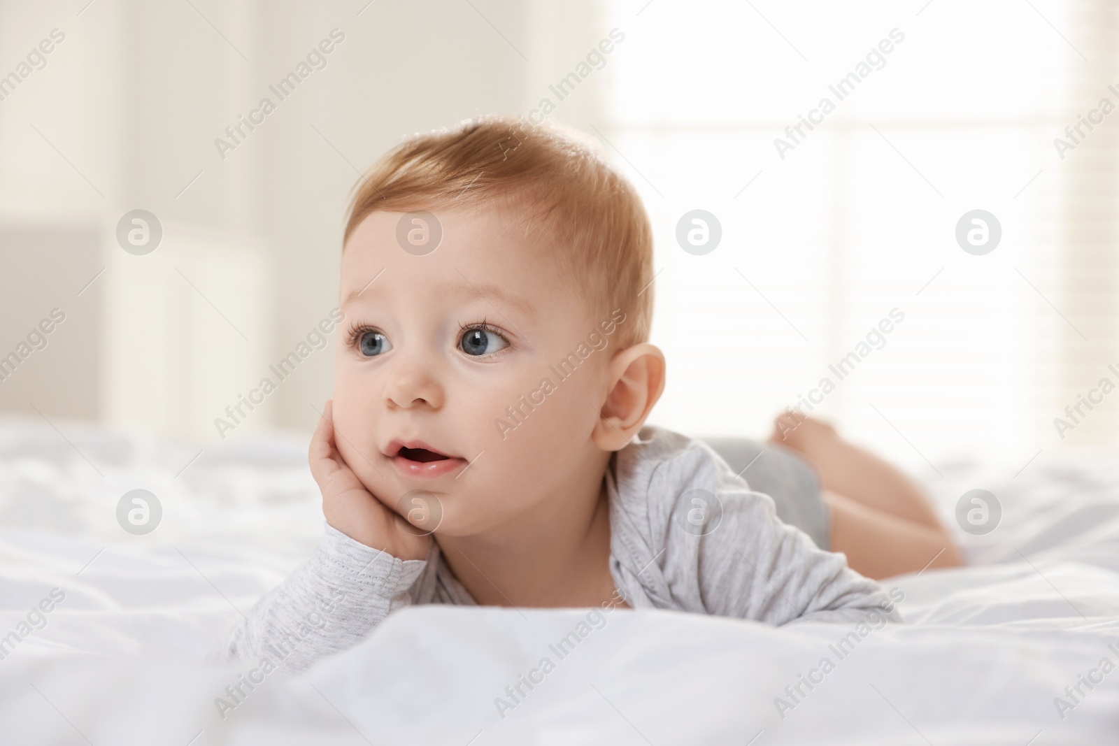 Photo of Cute little baby on bed at home