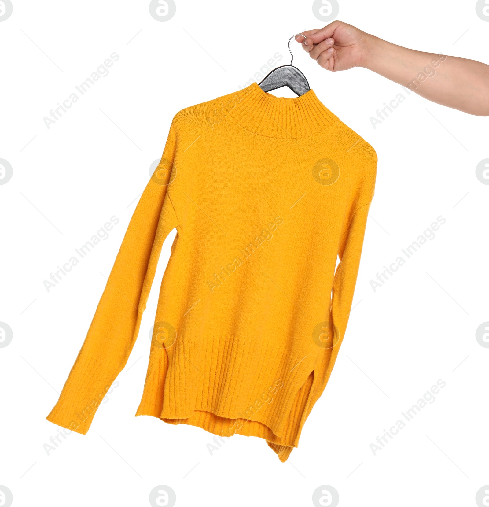 Photo of Woman holding hanger with orange sweater on white background, closeup