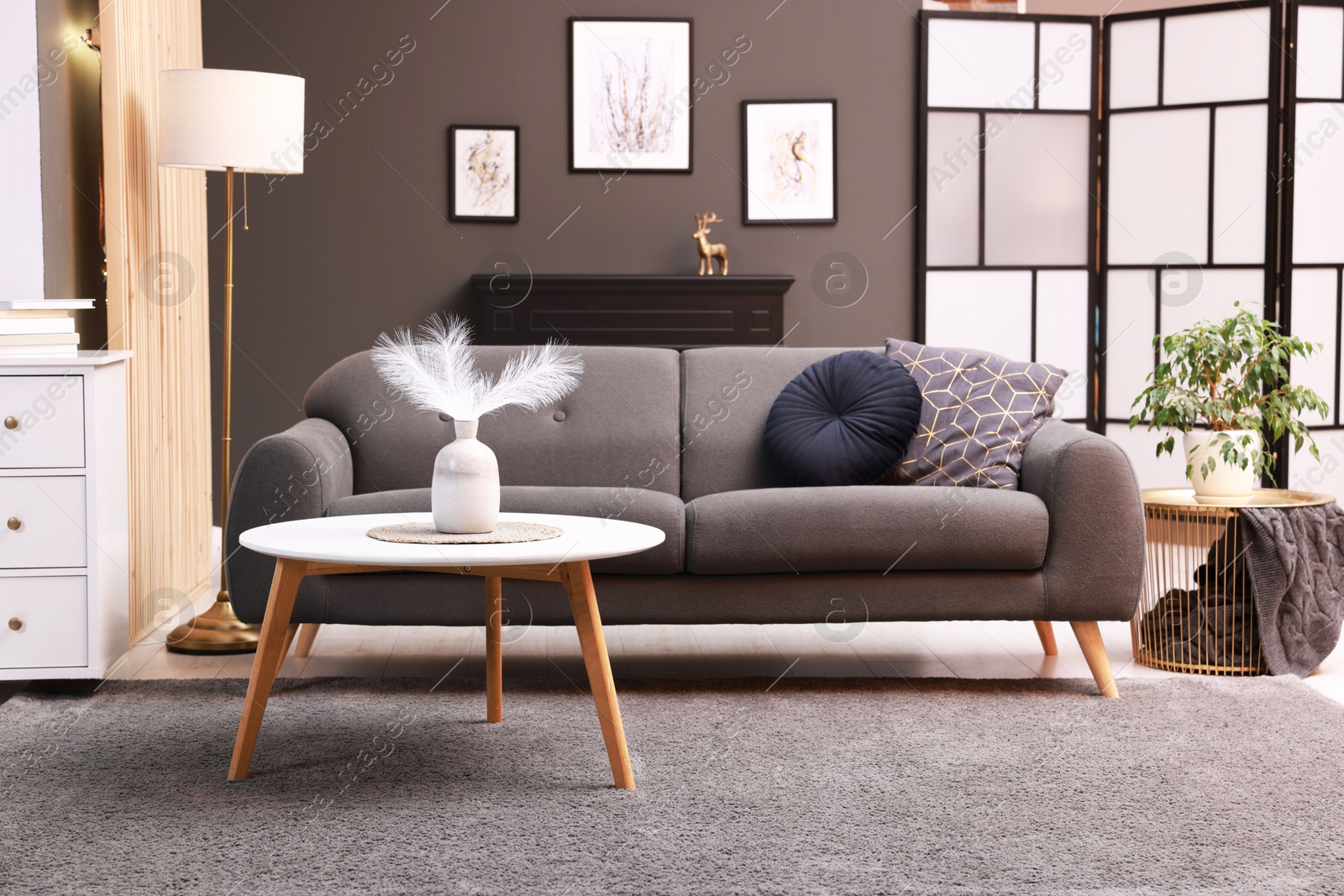 Photo of Stylish living room interior with comfortable sofa near grey wall