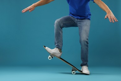 Photo of Man with skateboard on light blue background, closeup. Space for text