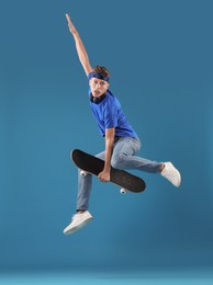 Photo of Man jumping with skateboard on light blue background