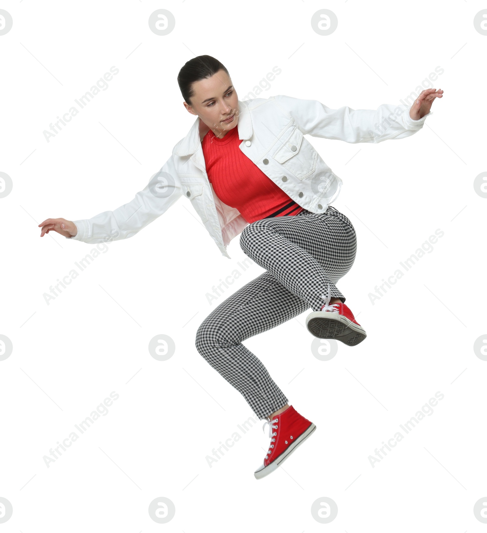 Photo of Beautiful female skater jumping on white background