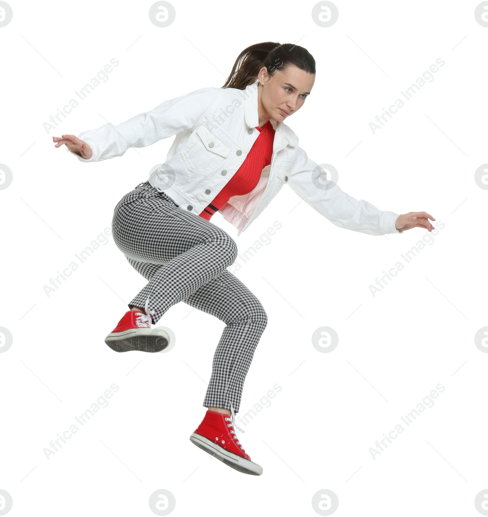 Photo of Beautiful female skater jumping on white background