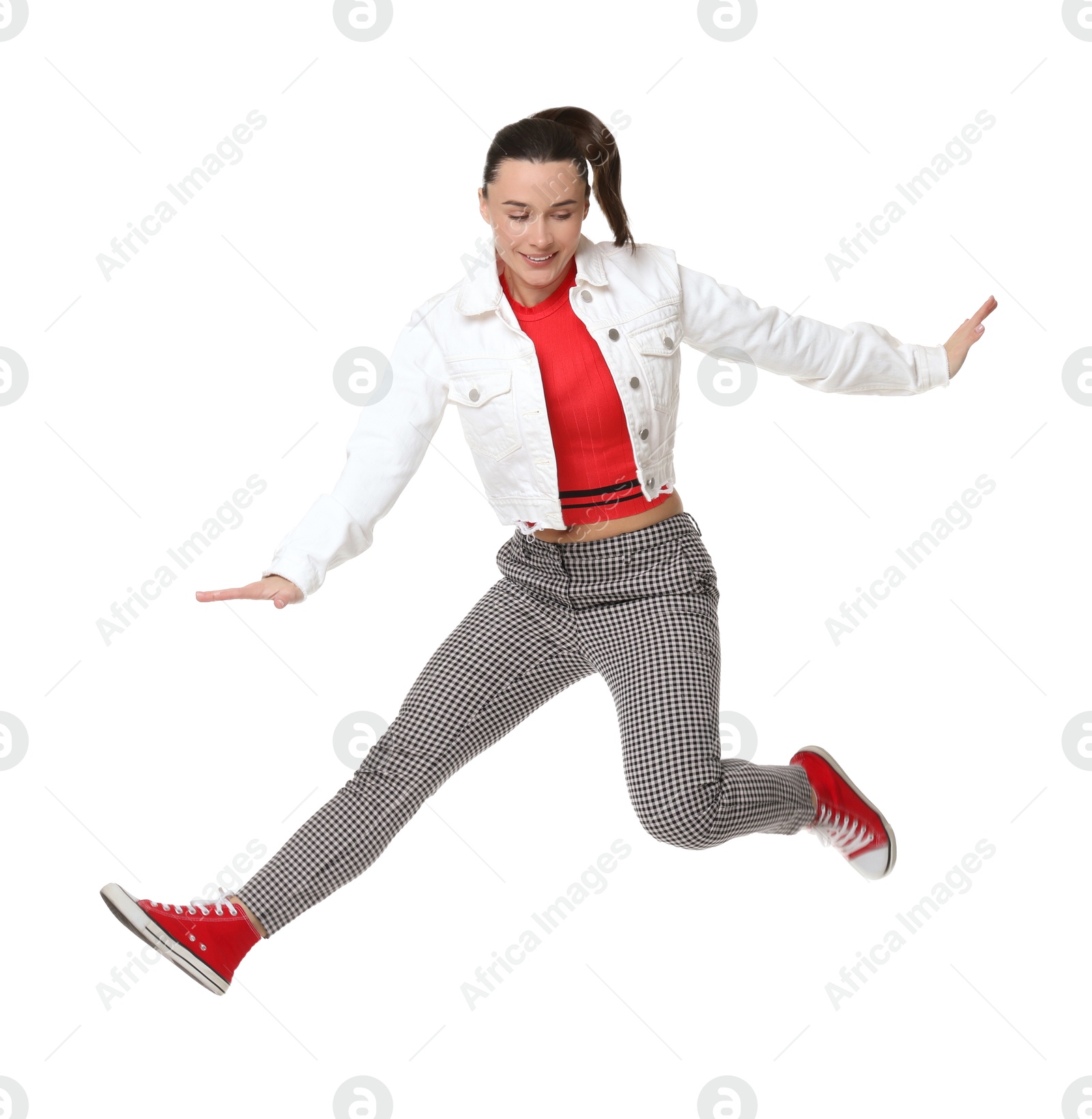 Photo of Smiling female skater jumping on white background