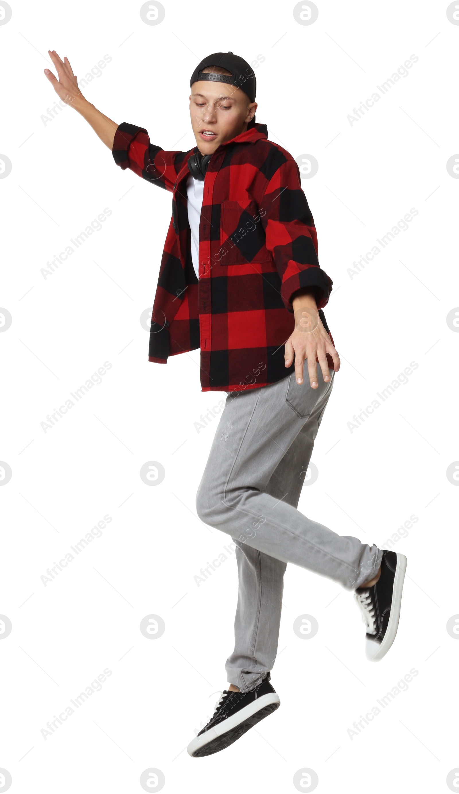 Photo of Handsome young skater jumping on white background