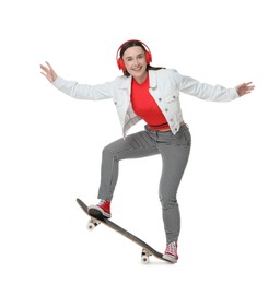 Photo of Smiling woman jumping with skateboard on white background