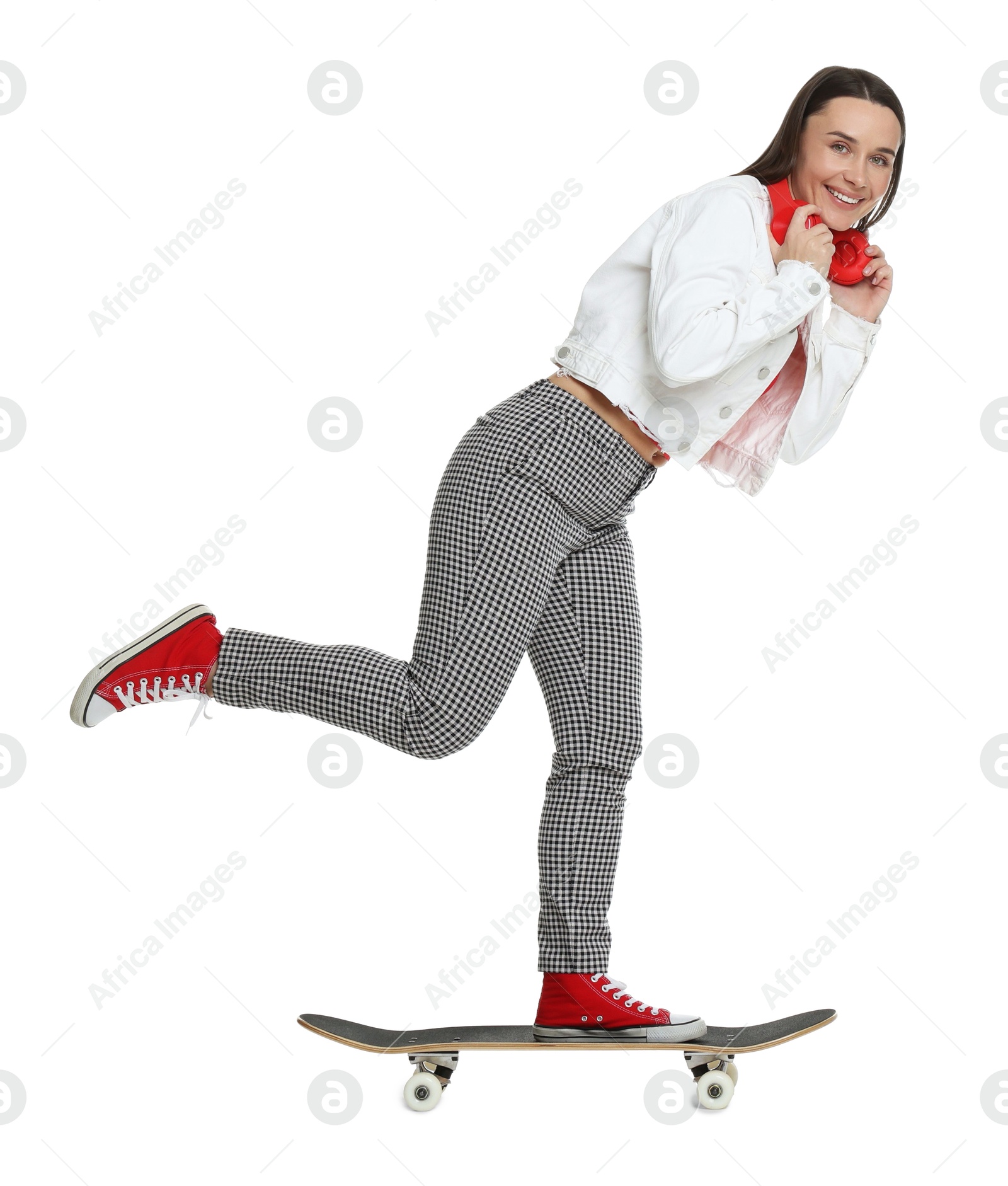 Photo of Smiling woman riding skateboard on white background