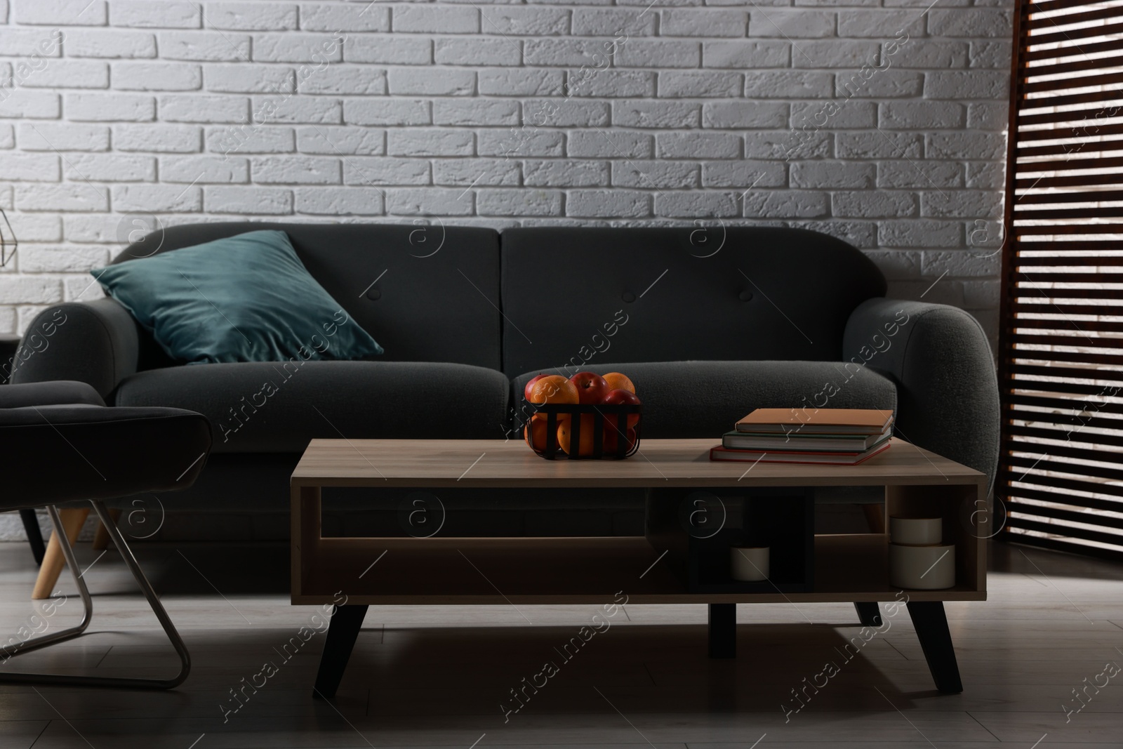 Photo of Comfortable sofa and coffee table in living room. Interior design