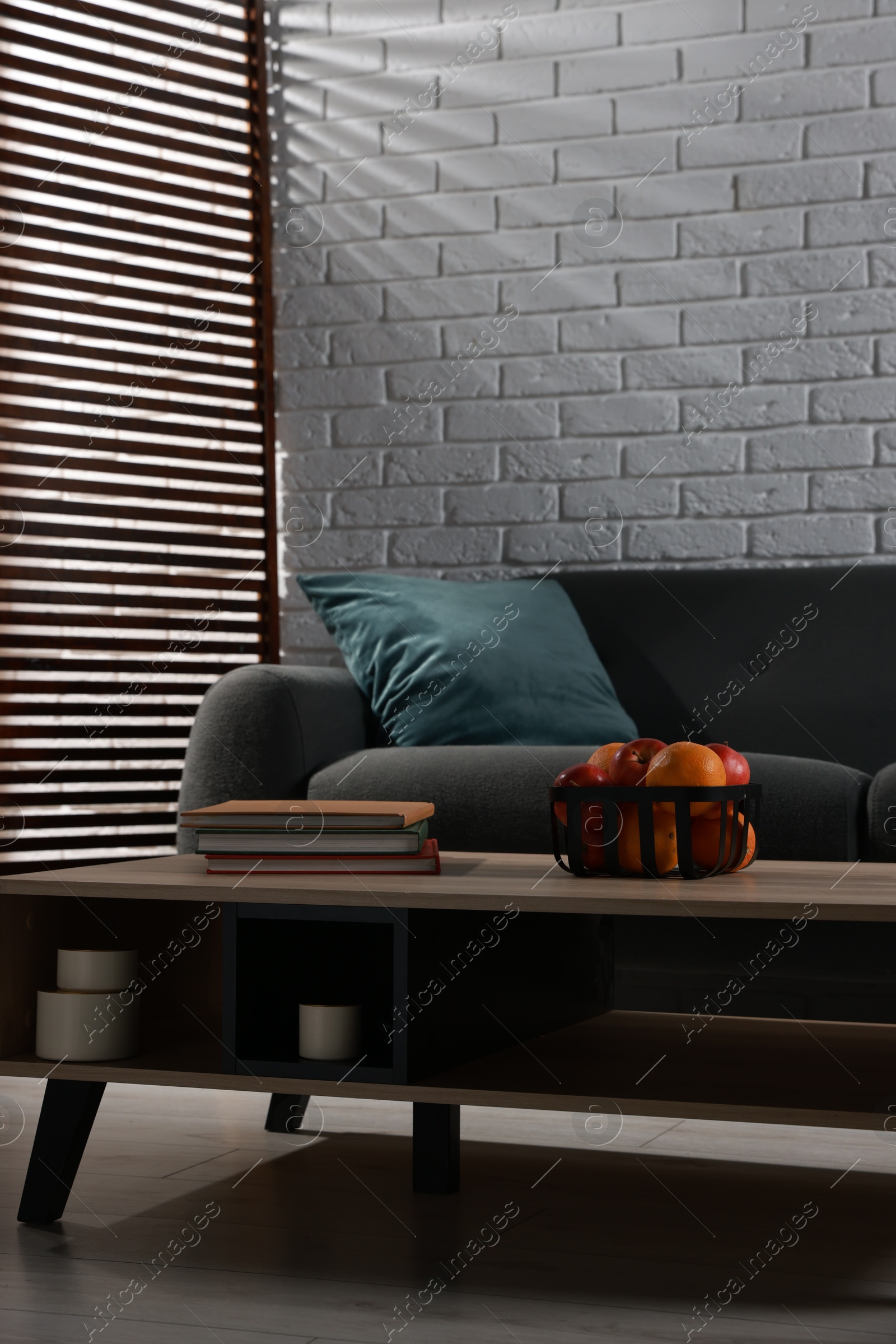 Photo of Comfortable sofa and coffee table in living room. Interior design