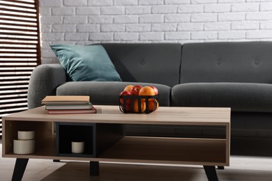 Photo of Comfortable sofa and coffee table in living room. Interior design