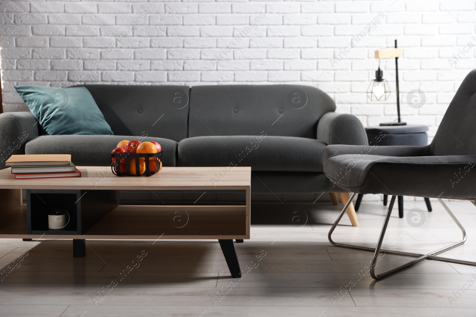 Photo of Comfortable sofa, armchair and coffee table in living room. Interior design