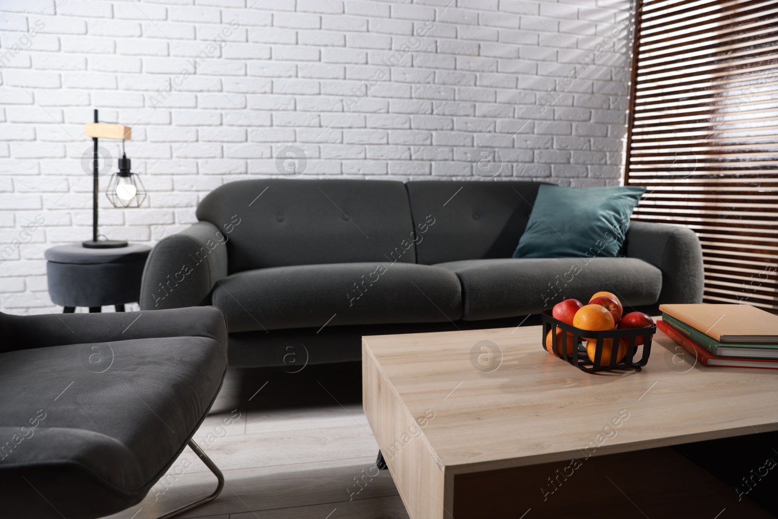 Photo of Comfortable sofa, armchair and coffee table in living room. Interior design