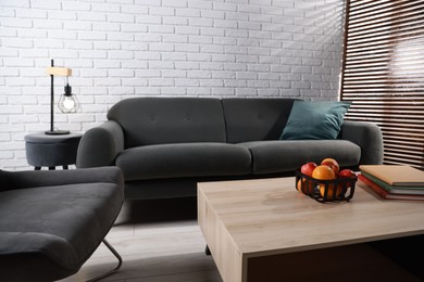 Comfortable sofa, armchair and coffee table in living room. Interior design