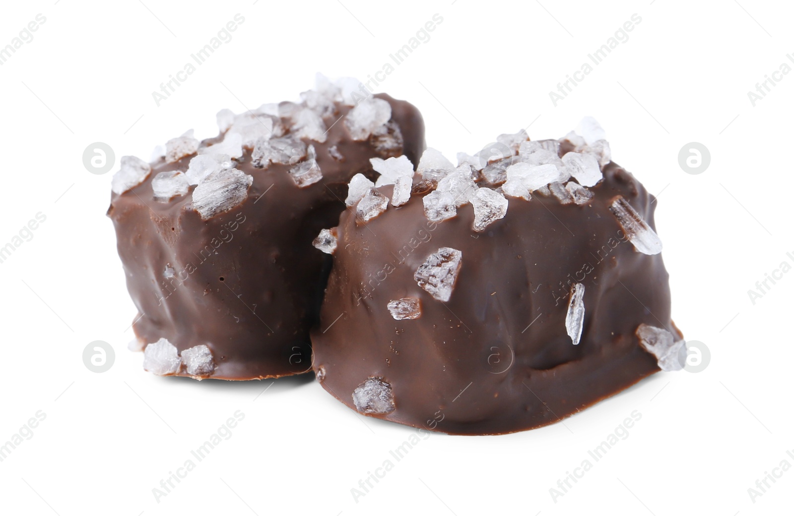 Photo of Tasty chocolate candies with salt isolated on white