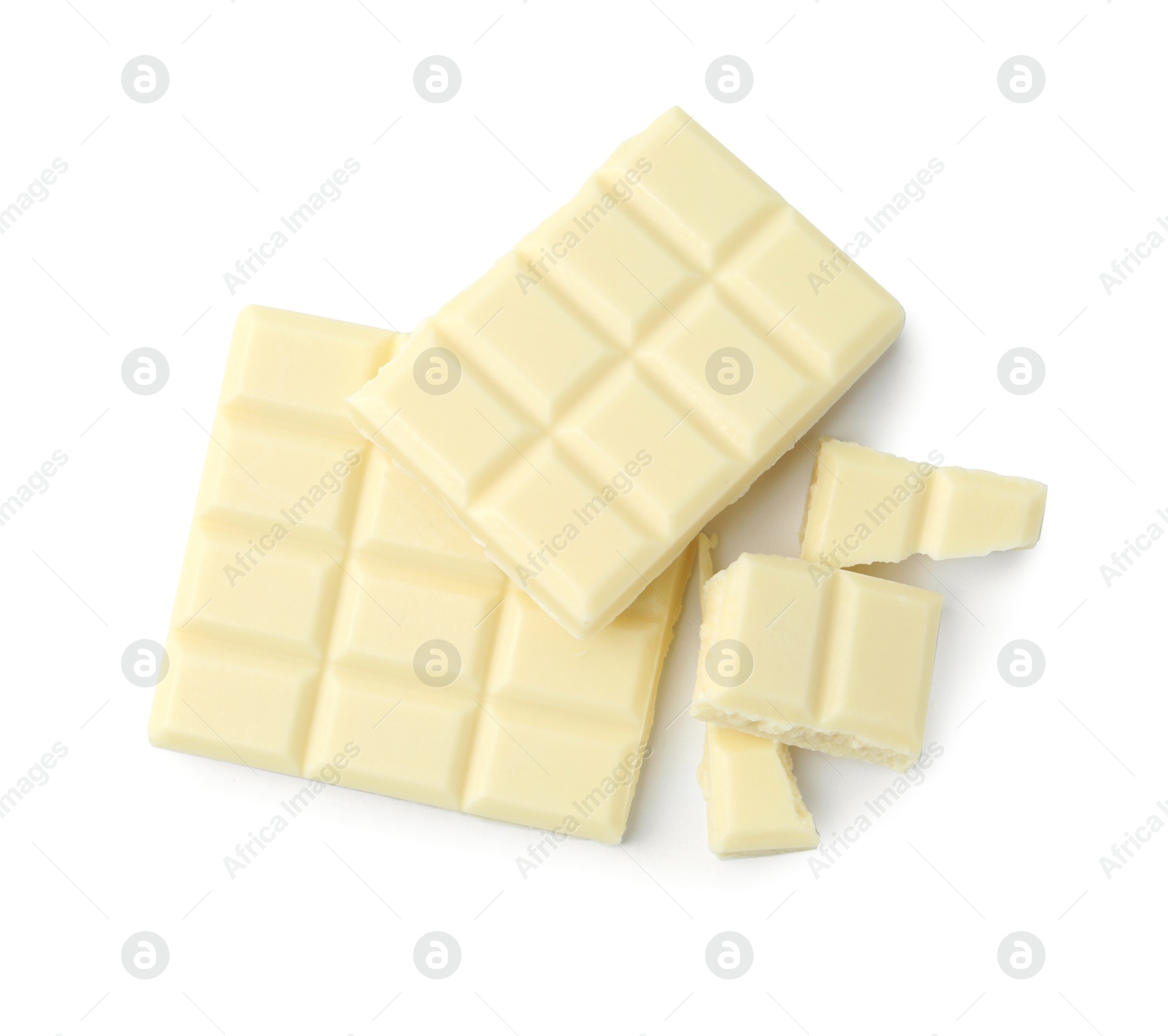 Photo of Pieces of delicious white chocolate isolated on white, top view