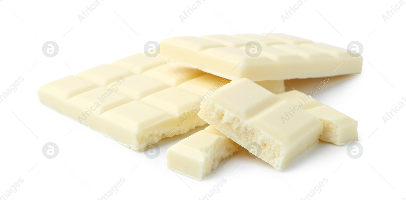 Photo of Pieces of delicious white chocolate isolated on white