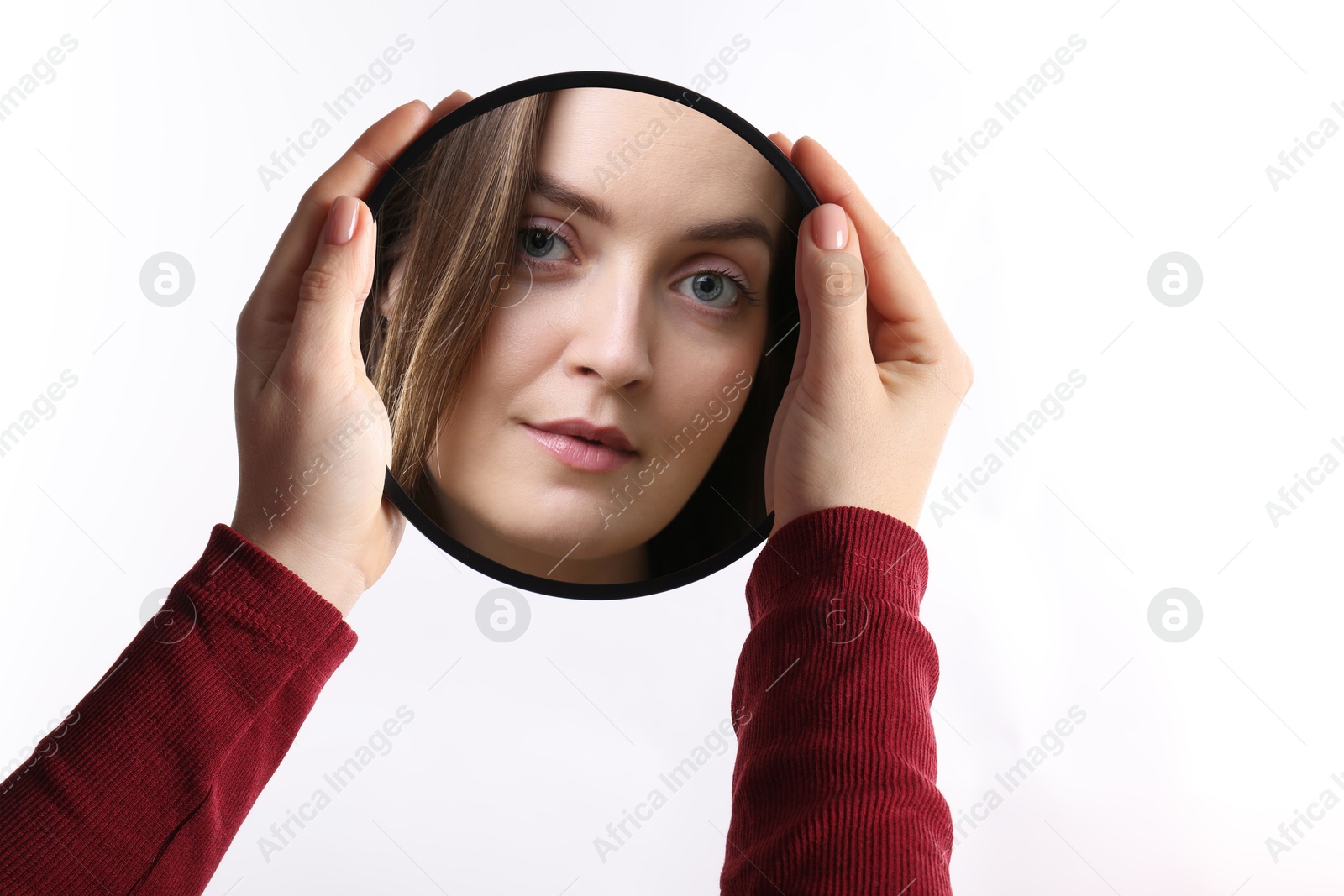 Image of Beautiful woman looking in small round mirror on white background, closeup