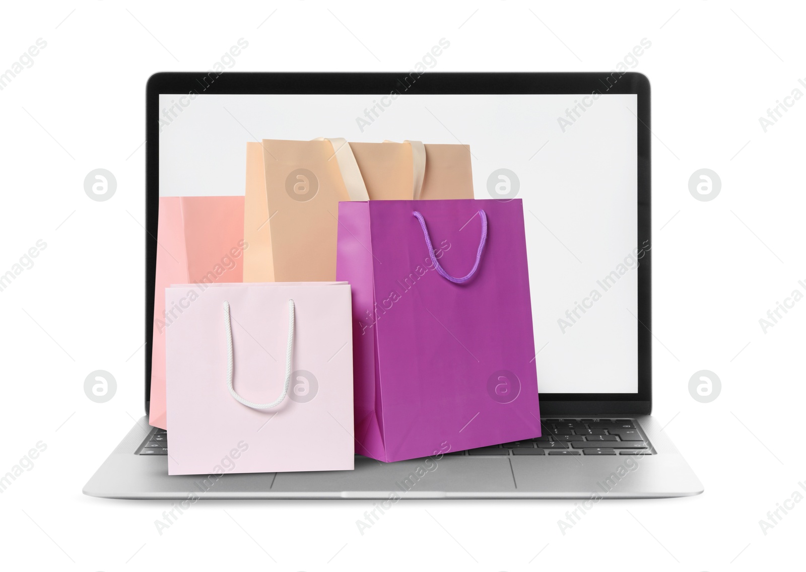 Image of Laptop with shopping bags isolated on white. Concept of online shopping, purchase via internet