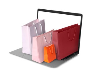 Image of Laptop with shopping bags isolated on white. Concept of online shopping, purchase via internet