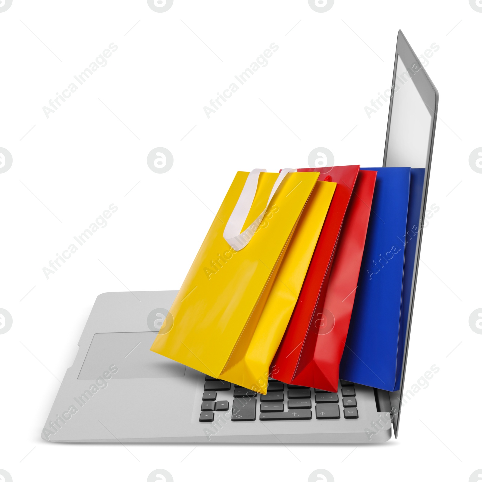 Image of Laptop with shopping bags isolated on white. Concept of online shopping, purchase via internet