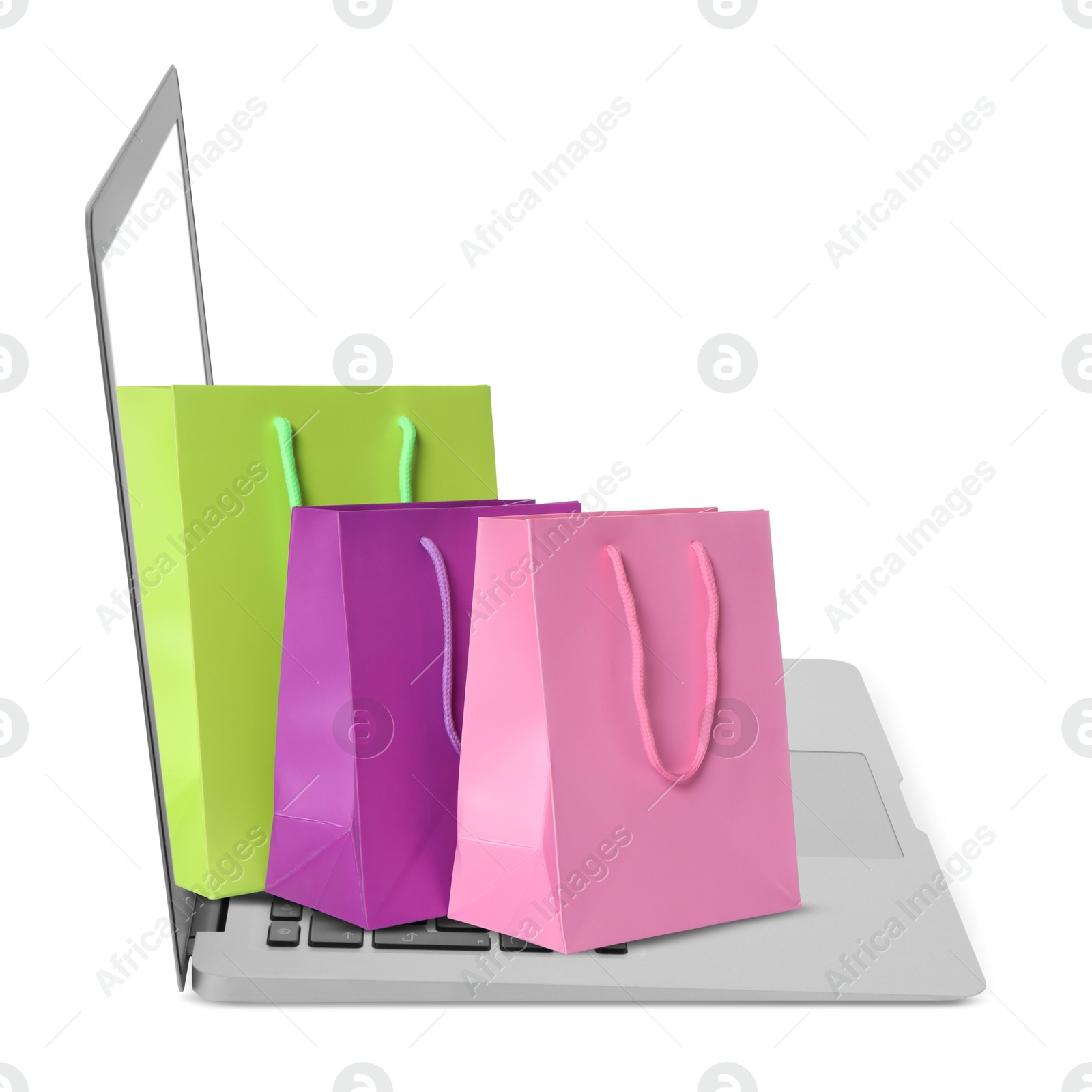 Image of Laptop with shopping bags isolated on white. Concept of online shopping, purchase via internet