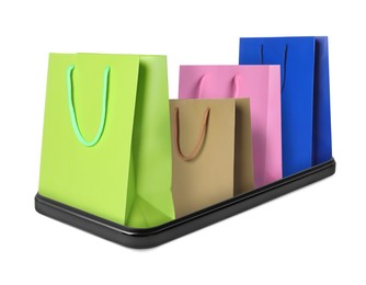 Image of Shopping bags sticking out of mobile phone isolated on white. Concept of online shopping, purchase via internet