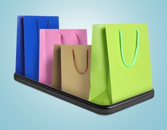 Image of Shopping bags sticking out of mobile phone on light blue background. Concept of online shopping, purchase via internet