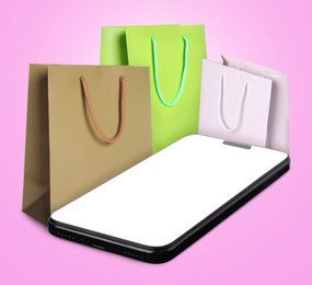 Image of Mobile phone and shopping bags on light violet background. Concept of online shopping, purchase via internet