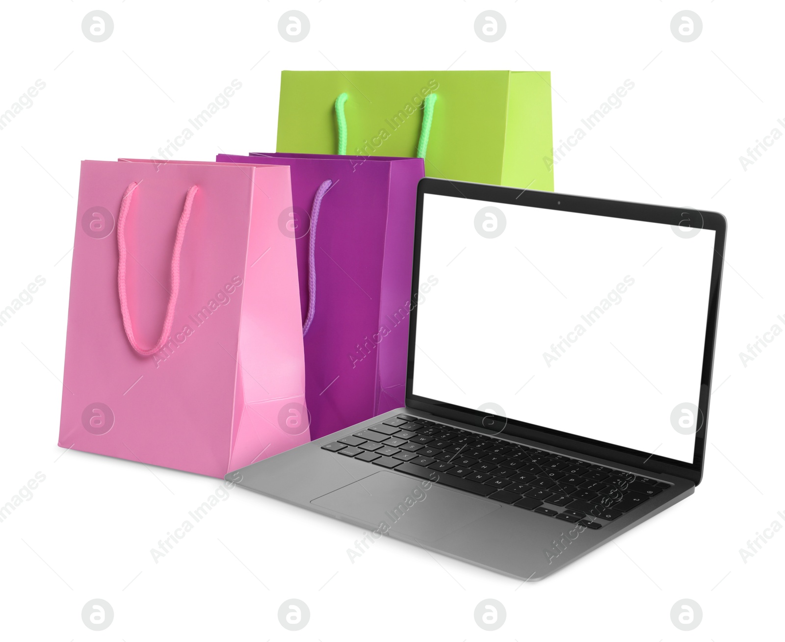 Image of Laptop and shopping bags isolated on white. Concept of online shopping, purchase via internet