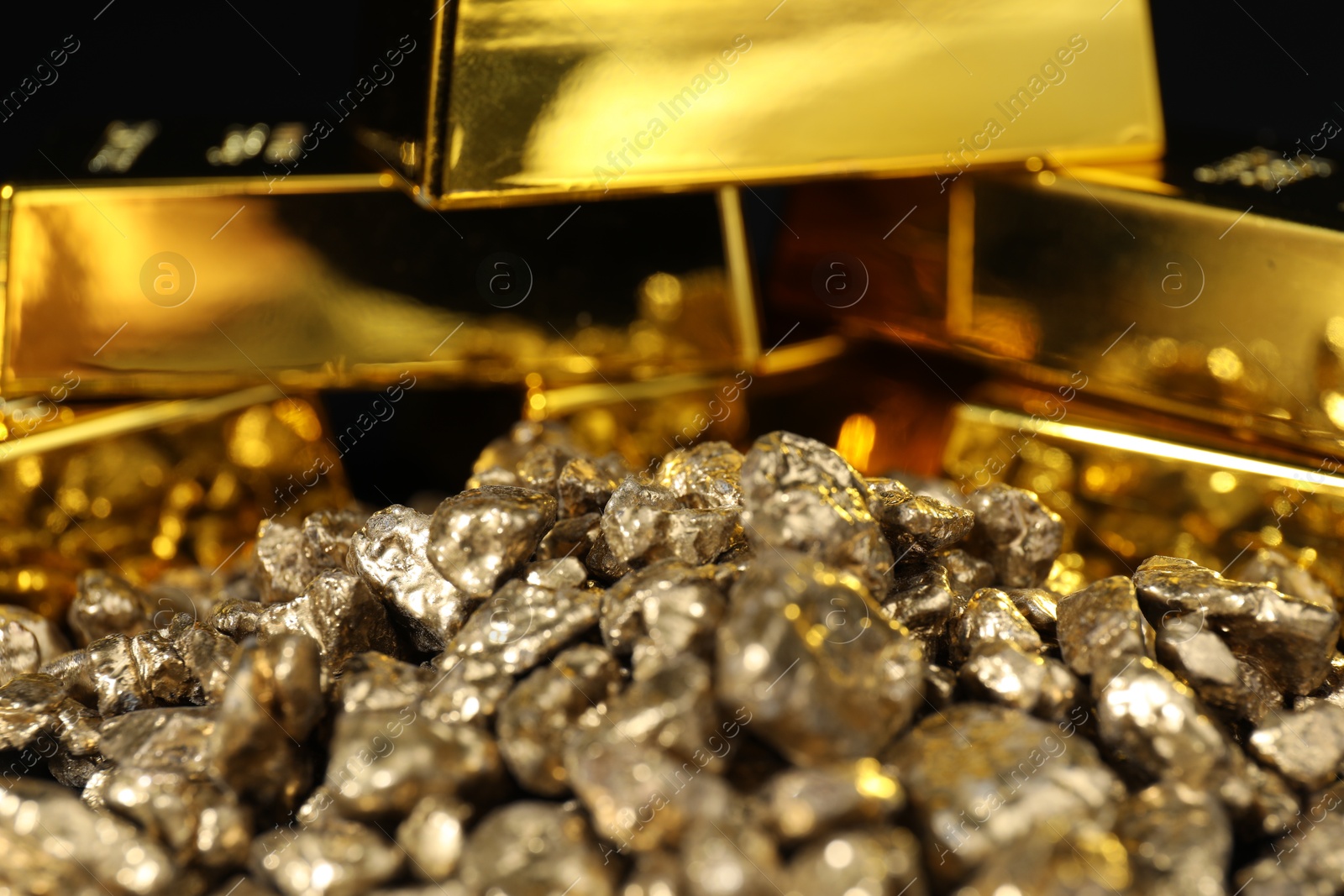 Photo of Gold nuggets and bars as background, closeup