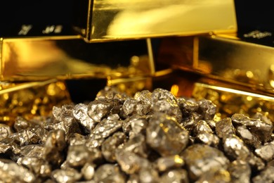 Photo of Gold nuggets and bars as background, closeup