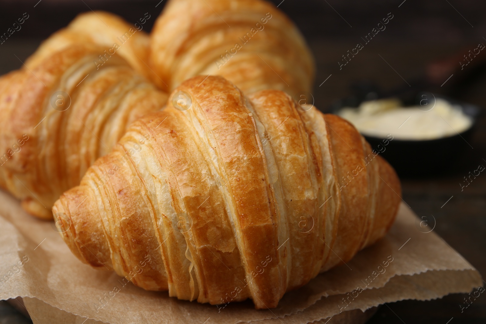 Photo of Tasty fresh croissants on table, closeup. Puff pastry