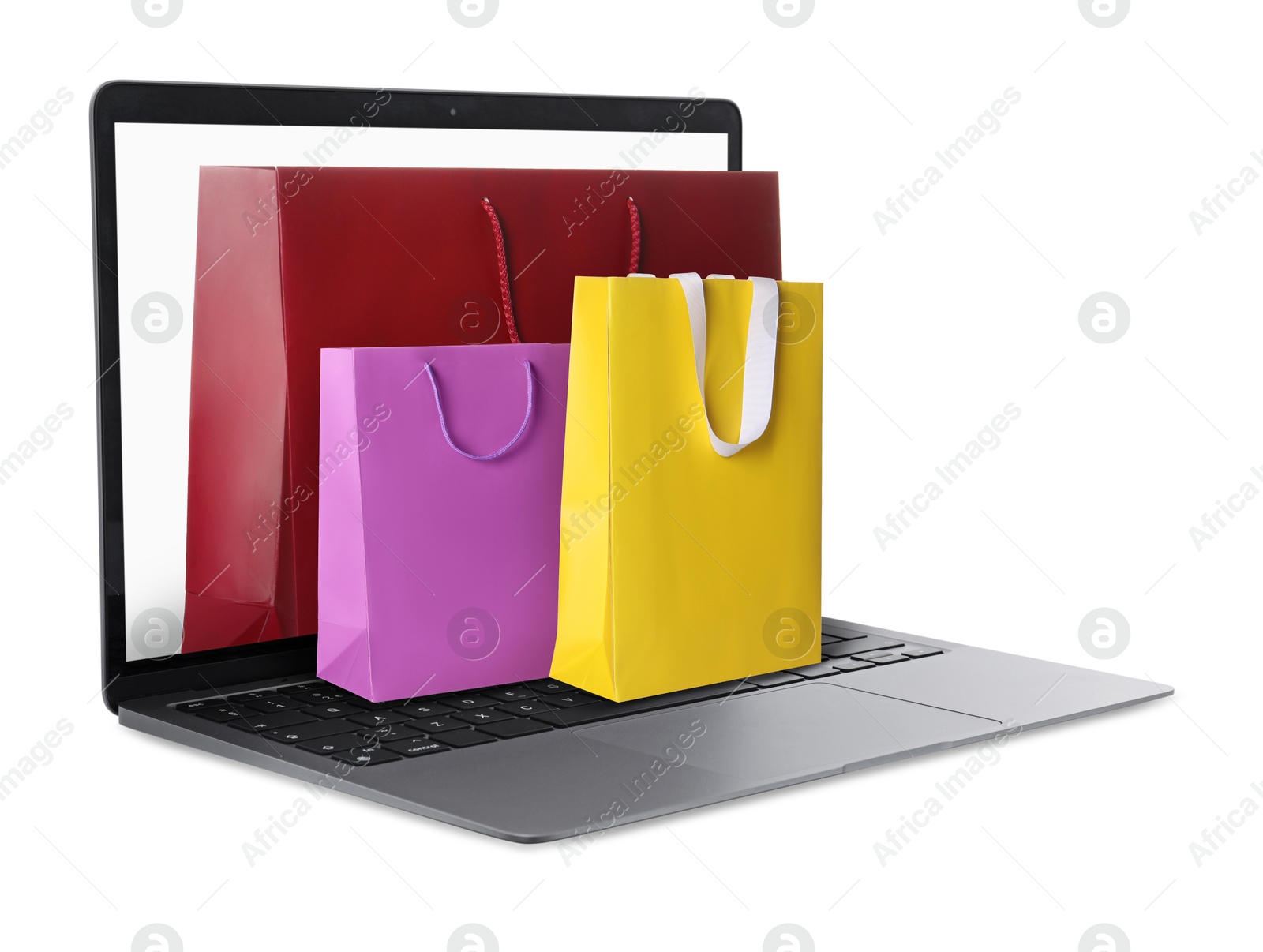 Image of Laptop with shopping bags isolated on white. Concept of online shopping, purchase via internet