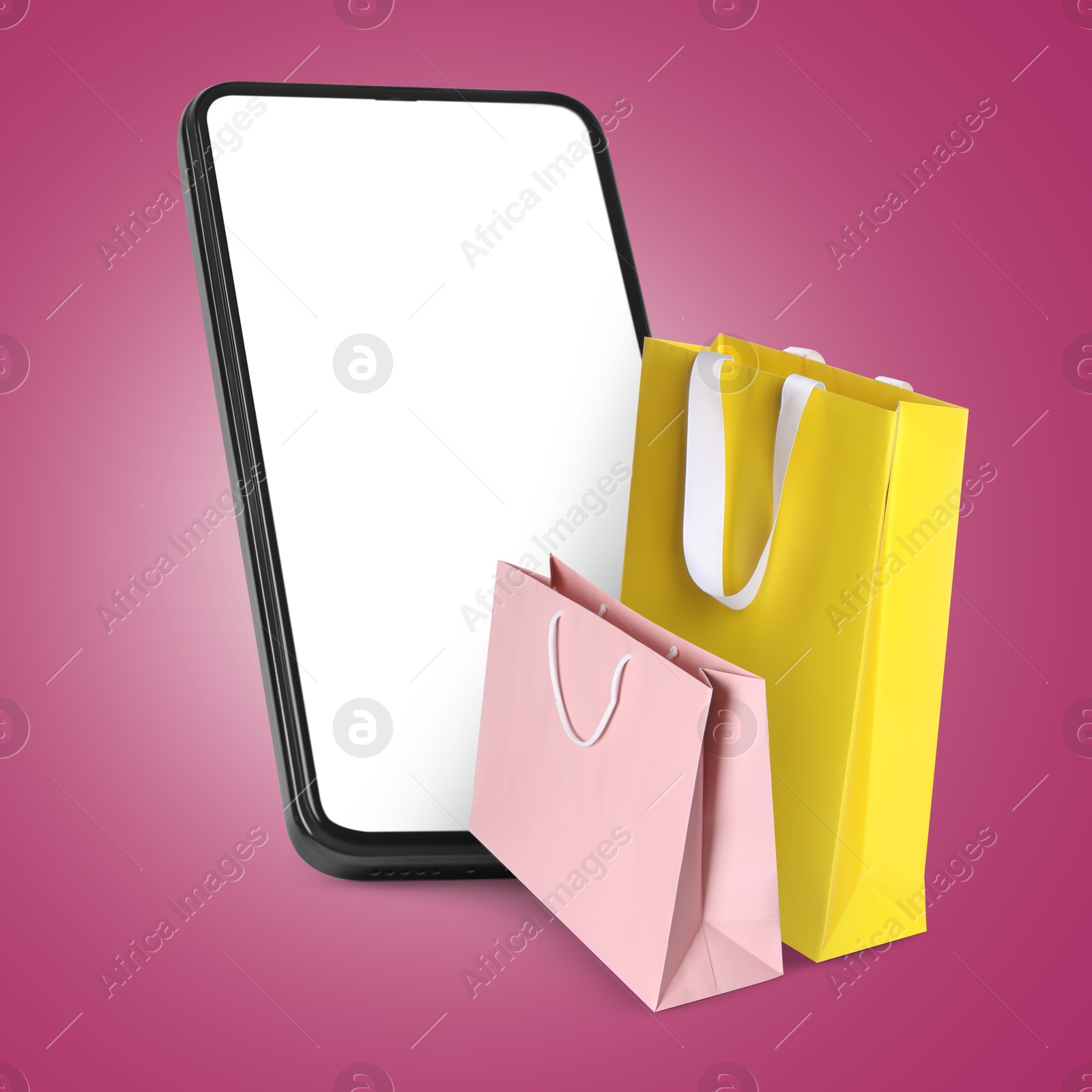 Image of Mobile phone with shopping bags on violet red background. Concept of online shopping, purchase via internet