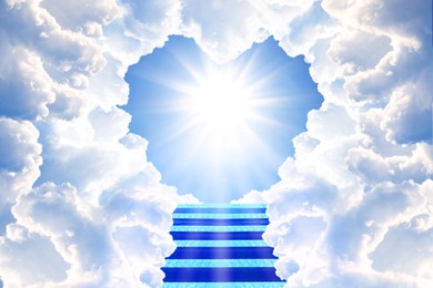 Image of Stairs leading to light in sky through heart shaped gap in clouds. Love of God, concept