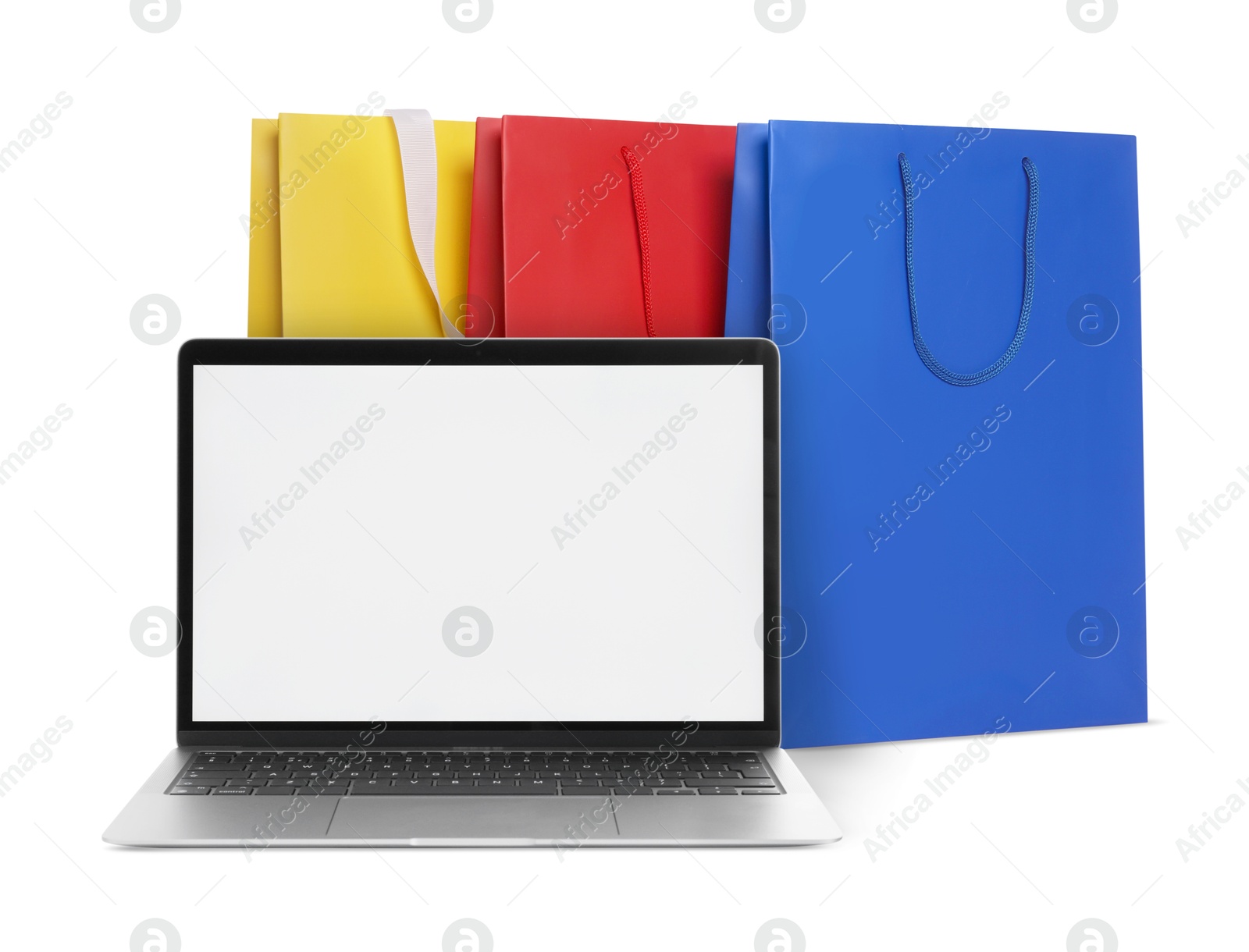 Image of Laptop and shopping bags isolated on white. Concept of online shopping, purchase via internet