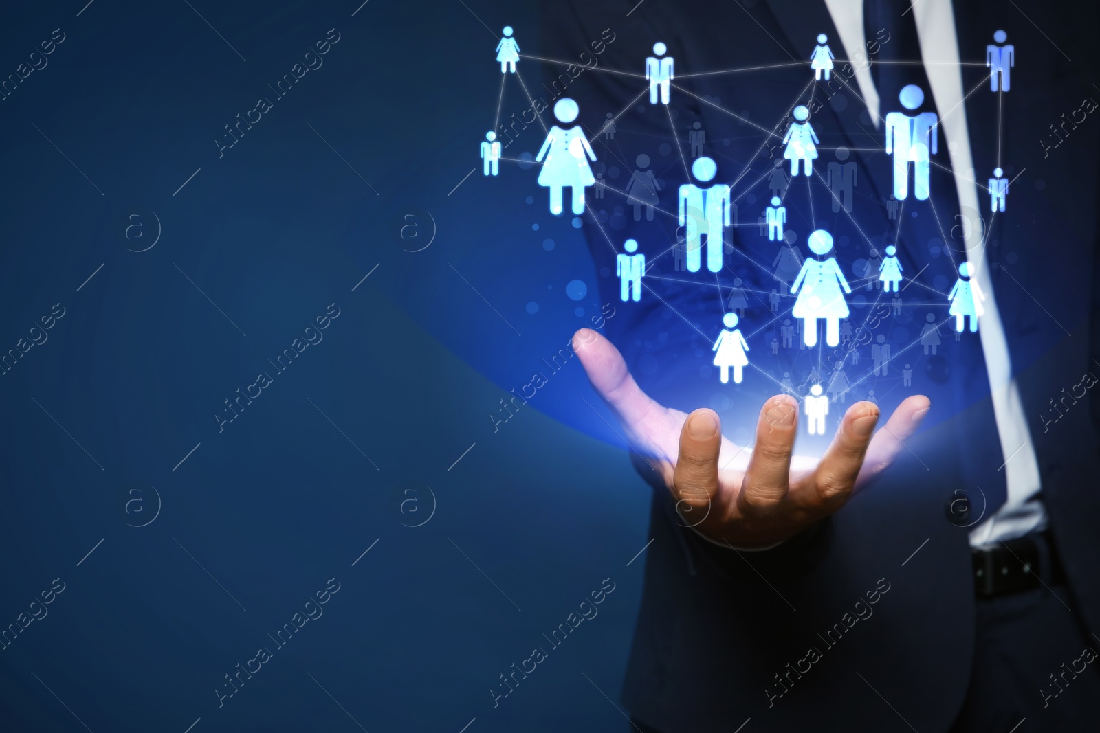 Image of Human resource. Businessman holding virtual scheme with people figures on dark blue background, closeup