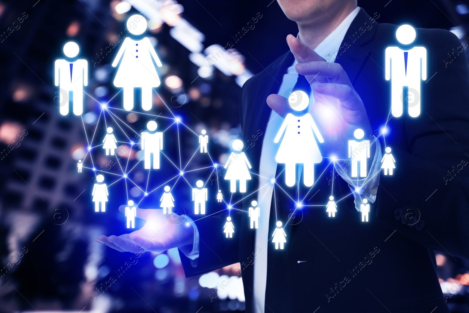 Image of Human resource. Businessman holding virtual scheme with people figures against night cityscape, closeup