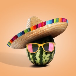 Image of Senor watermelon with Mexican sombrero hat and sunglasses on pale orange background