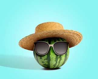 Image of Watermelon with straw hat and sunglasses on turquoise background