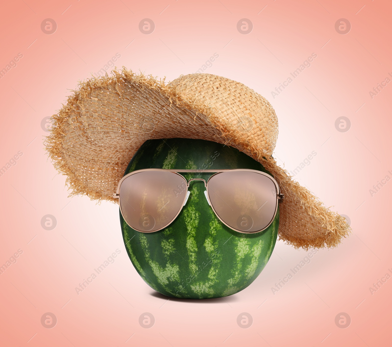 Image of Watermelon with straw hat and sunglasses on apricot color background