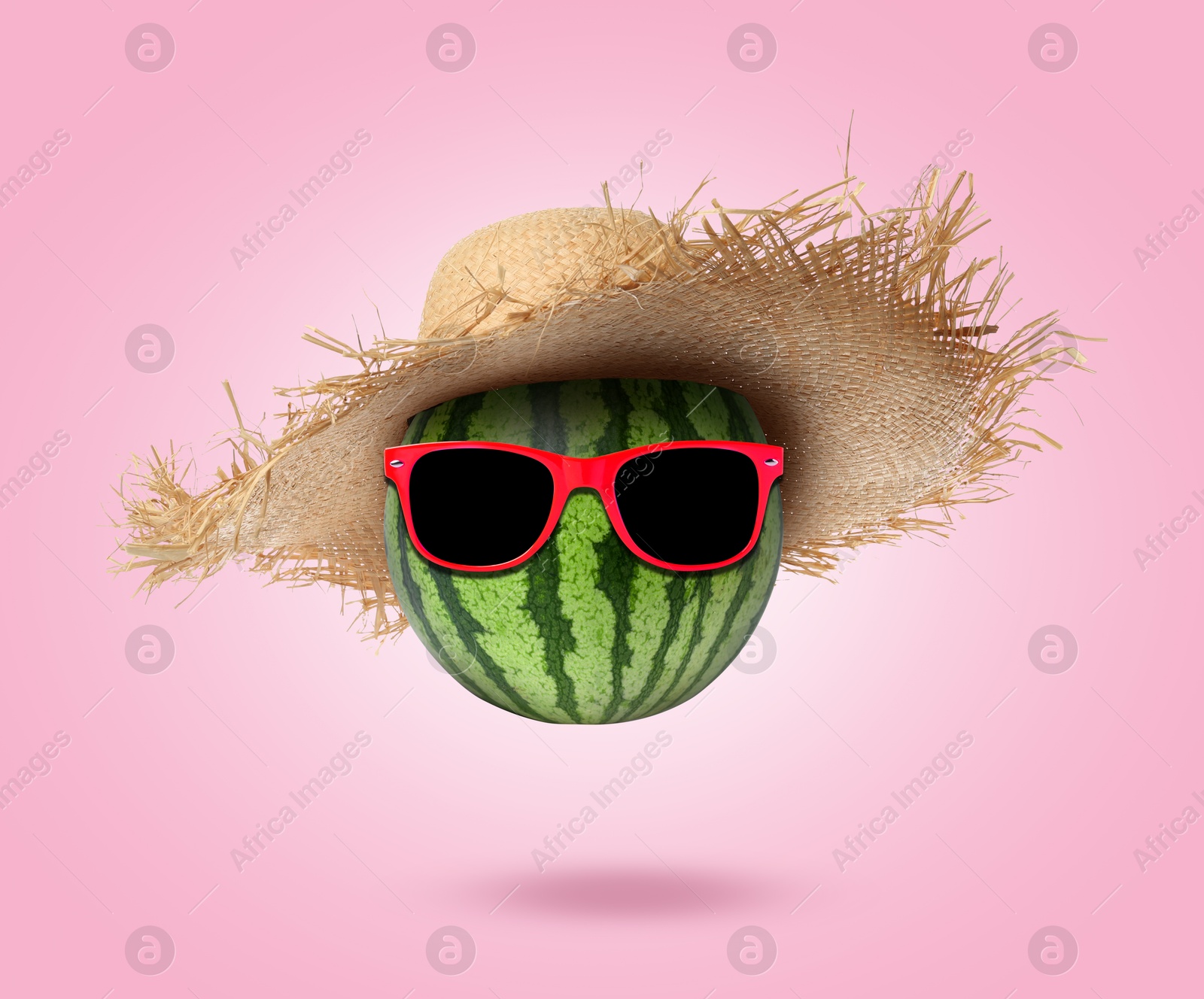 Image of Watermelon with straw hat and sunglasses on pink background