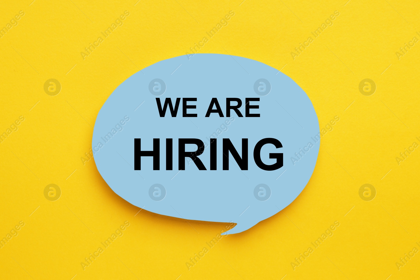 Image of Paper note with text We Are Hiring on yellow background, top view. Human resource