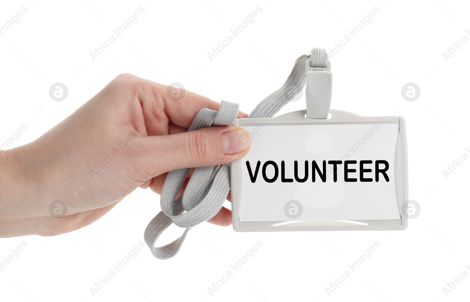 Image of Woman holding badge with word Volunteer on white background, closeup