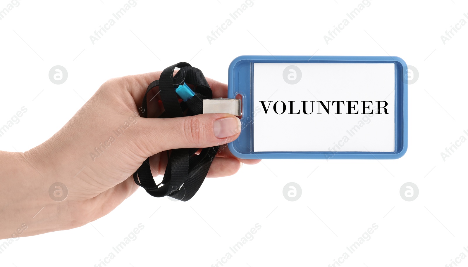 Image of Woman holding badge with word Volunteer on white background, closeup