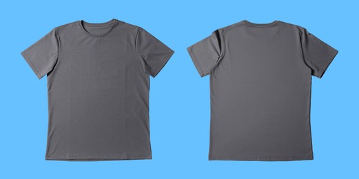 Image of Blank grey t-shirt on light blue background, back and front. Mockup for design