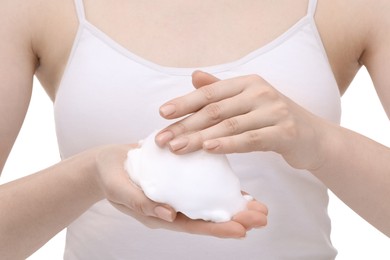 Photo of Woman with cleansing foam on hands against white background, closeup