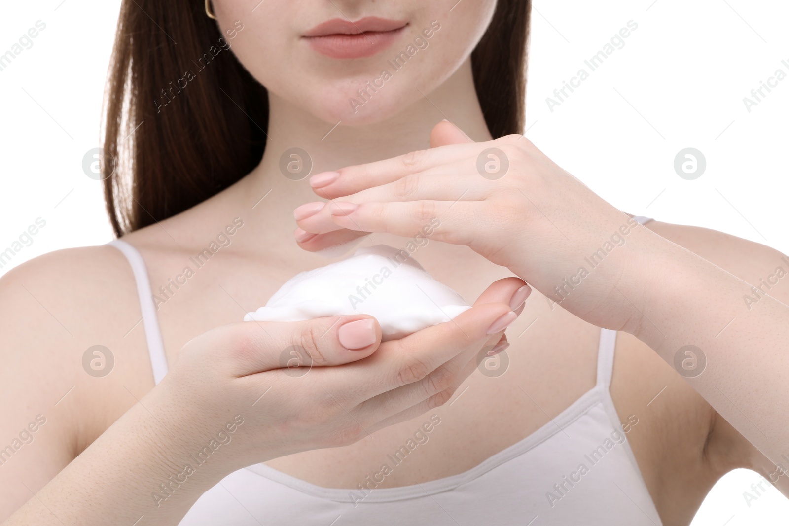 Photo of Woman with cleansing foam on hands against white background, closeup