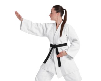 Photo of Young woman in kimono practicing karate on white background