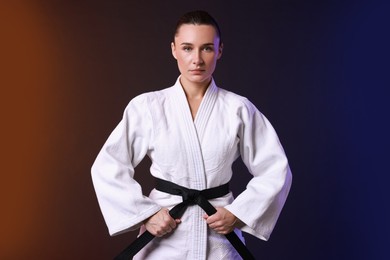 Photo of Karate fighter in kimono on color background